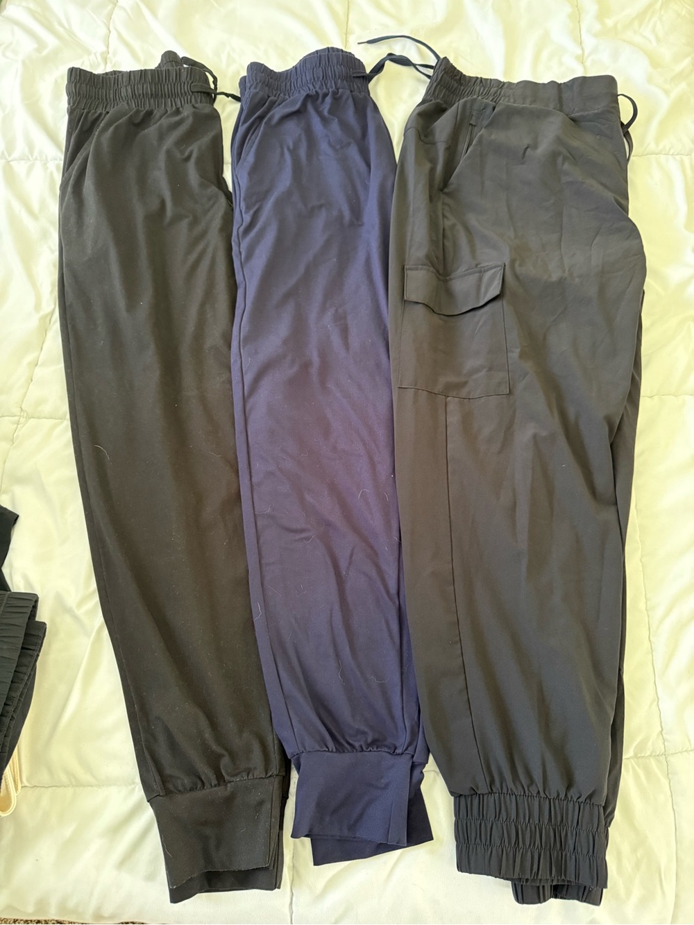 Three Elastic Cuff Joggers in Black and Navy.